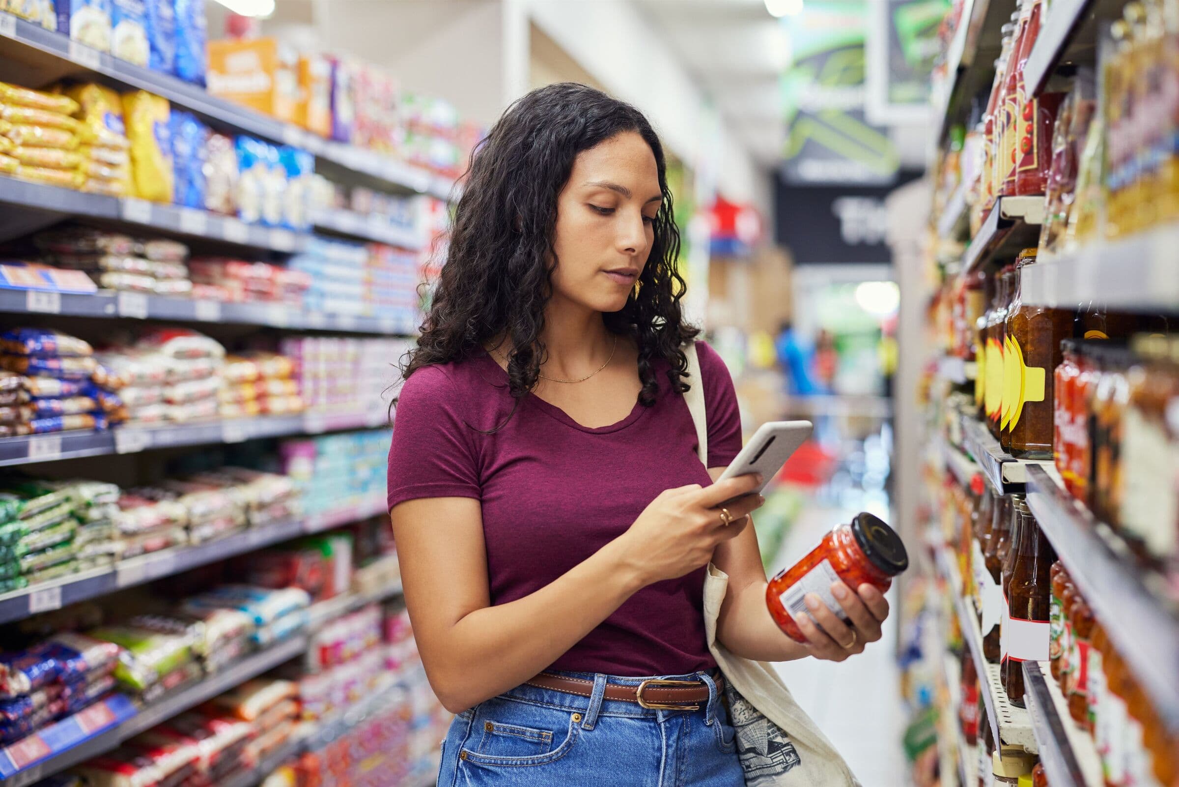 Woman comparing grocery prices on her phone