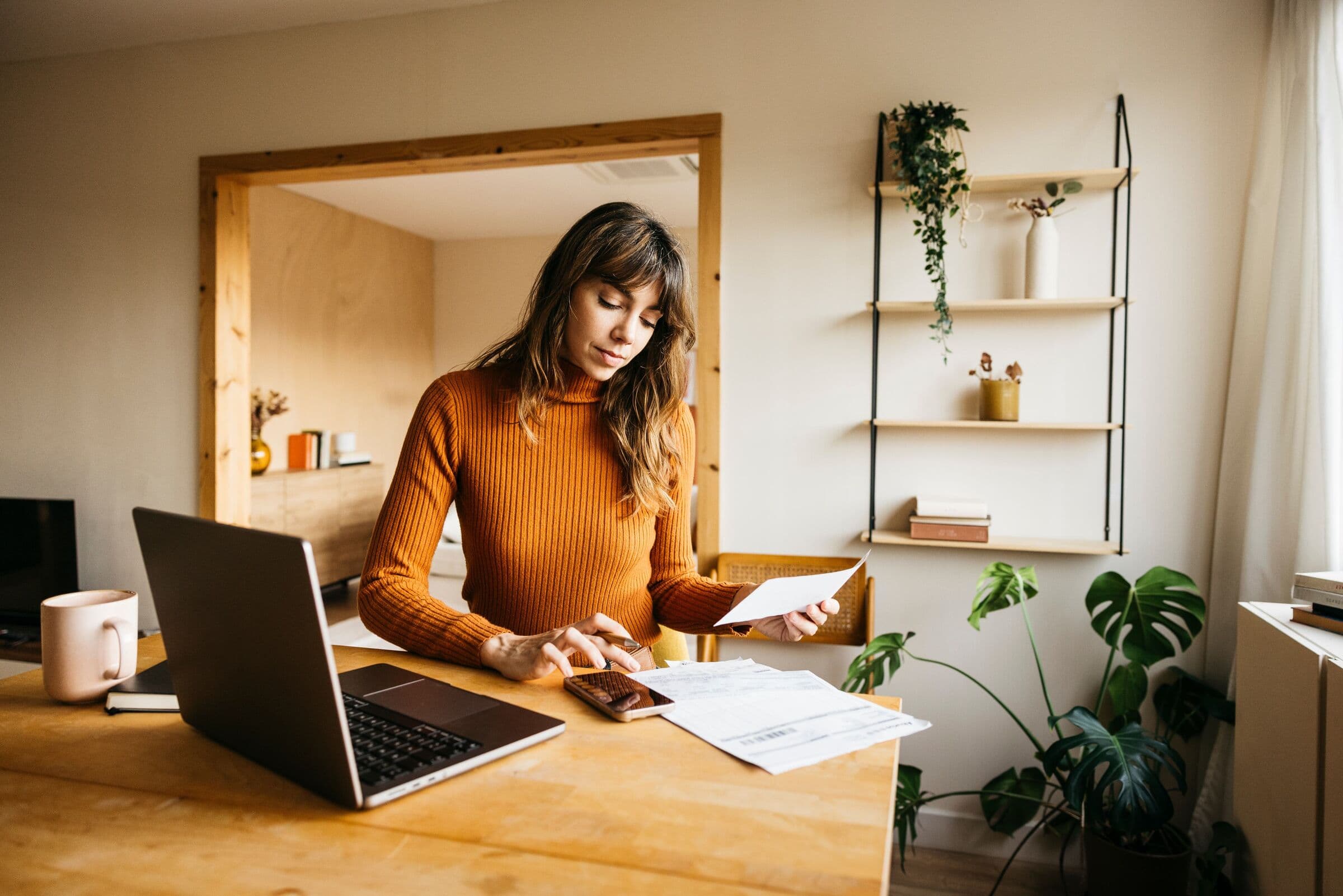 Woman reviewing her finances on a laptop